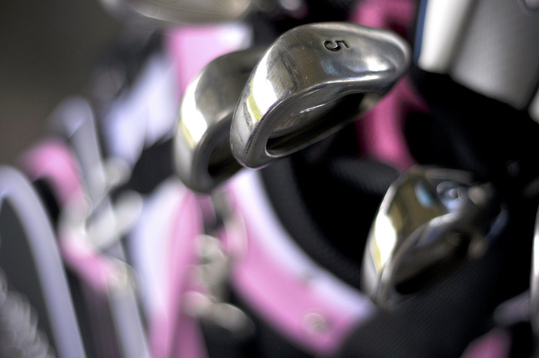 A close up image of some golf clubs.