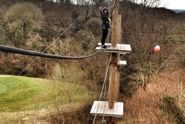 A girl tries out the high ropes at Celtic Manor